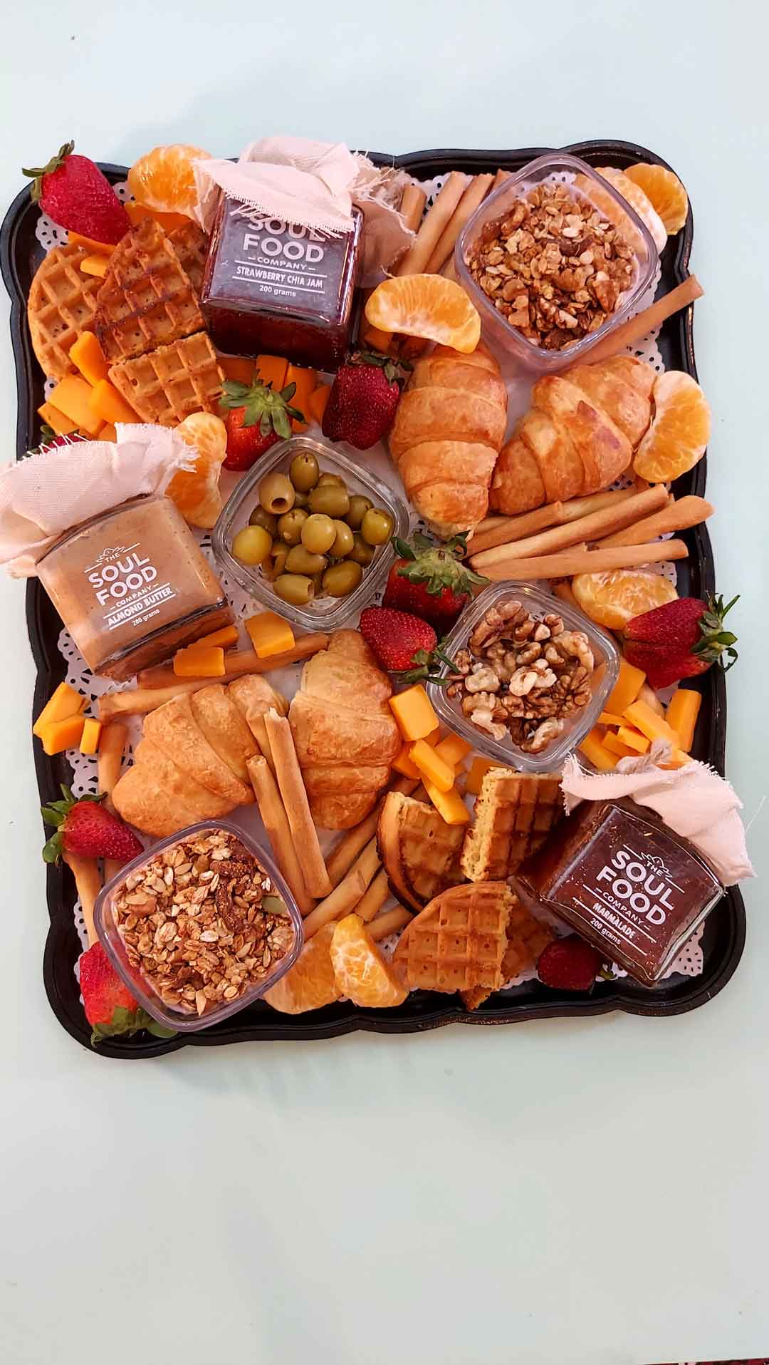 peanut and almond butter, strawberry jam and marmalade in a breakfast tray